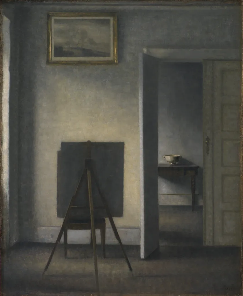 Vilhelm Hammershoi, Interior with the Artist's Easel (1910): an empty grey room, a canvas turned away on an easel, and an open door into the next room.